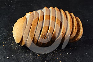 Isolate of white loaf of bread with sliced Ã¢â¬â¹Ã¢â¬â¹pieces on a black background